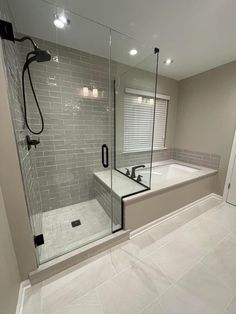 a bathroom with a walk in shower next to a bath tub