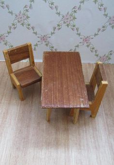 two wooden chairs and a small table on the floor