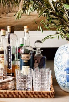 an assortment of liquor bottles and glasses on a table