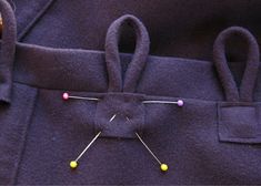 the back of a purple jacket with buttons and pins on it