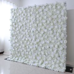 a large white flower covered wall in an empty room