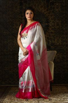 The electrifying fuchsia pink is balanced by a sedate white to create a combination which is bold yet elegant. The peacock motifs enhance the beauty of the saree by adding an element of interest. This saree is as unique as your smile!   Details Fabric: Tissue and Zari fine blend handloom Color and Design: White-fuchsia Fabric Color, Cotton Yarn, Elegant