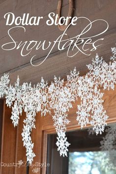 the words dollar store snowflakes are hanging from a wooden door with white snow flakes on it