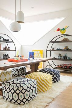 a living room filled with lots of furniture and shelves full of toys on top of it