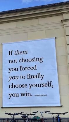 a large sign on the side of a building that says if them not choosing you forced you to finally choose yourself, you win