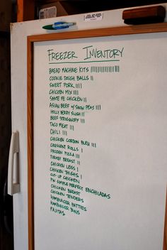 the freezer inventory board is white with green writing on it