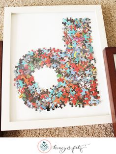 a framed puzzle piece with the number five in it's center, surrounded by other pieces