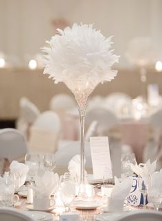 the centerpieces on this table are all white