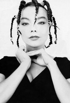 a black and white photo of a woman with braids