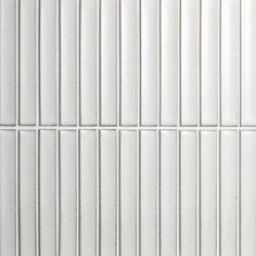 a white tiled wall with lines on it