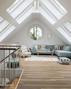 a living room filled with furniture and a skylight