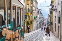 Explore the vibrant Bairro Alto neighborhood in Lisbon 🏘️, where you can ride Lisbon's historic funiculars 🚋, learn traditional crafts at Retrosaria Pomar 🧵, and indulge in a culinary tour featuring Portuguese tascas and international restaurants 🍽️. Monuments, Lisbon, Porto City, Street View, Portugal Travel, City, Portugal Vacation, Picturesque