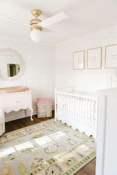 a baby's room with a crib, dresser and mirror