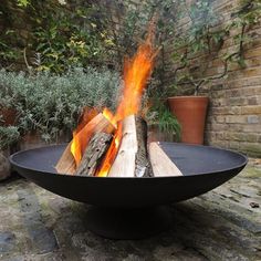 a fire pit sitting on top of a stone floor