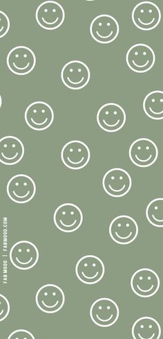 a green background with white smiley faces