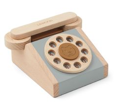 a wooden toy phone with an animal on it