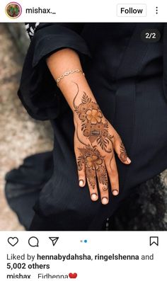 a woman's hand with henna tattoos on her left arm and the words, follow