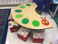 a child's table and toy chest in a classroom