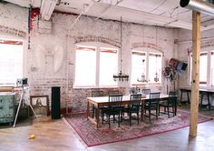 an old brick room with tables and chairs