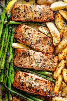 grilled salmon and asparagus with potatoes on a baking sheet