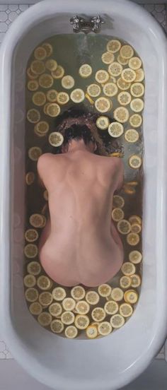 a bathtub filled with gold coins and a woman's head in the water