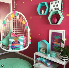 a room with pink walls and colorful decorations