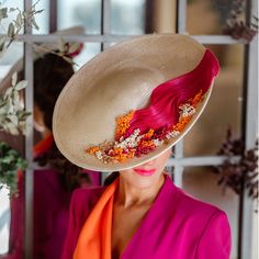 a woman wearing a hat with flowers on it