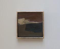 a painting hanging on the wall next to a white wall