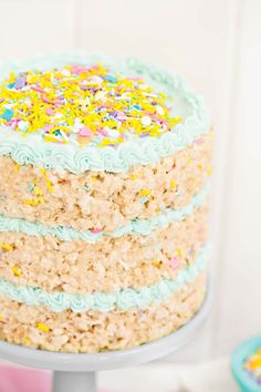 a three layer cake with sprinkles and frosting