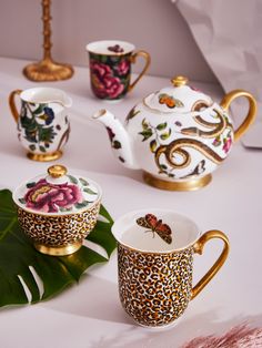 the tea set is decorated with flowers and gold trimmings