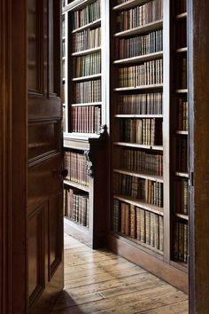 an open bookcase with many books on it's sides in a room filled with wooden
