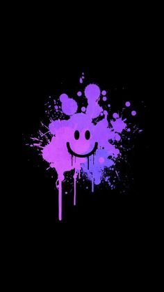 a smiley face with paint splattered on it's side, in purple and blue