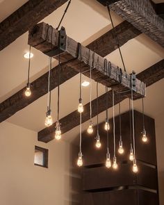 the light bulbs are hanging from the beam in the room, which is decorated with wood beams