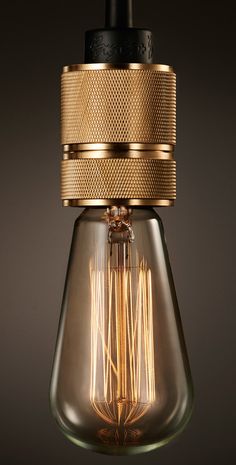 an old fashioned light bulb hanging from a ceiling fixture with a gold finish on it