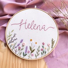 a embroidery kit with the word feleena written in it and some dried flowers