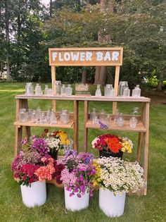 flower bar with flowers in buckets and jars