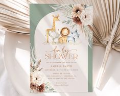 a baby shower is shown with flowers and giraffes on the front cover