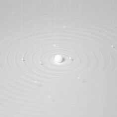 a white object floating on top of a body of water with circles in the middle