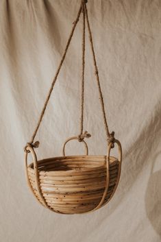 a basket hanging from a rope on a white background