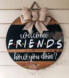 a wooden sign with the words welcome friends how do you doin? and a bow on it