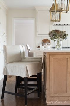 a kitchen with an island and chairs in it