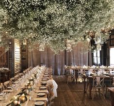 an instagramted photo of a dining room with tables and chairs covered in white flowers