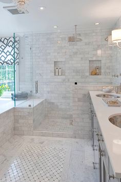 a large bathroom with two sinks and a bathtub in it's center area