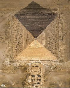 an aerial view of two pyramids in the desert