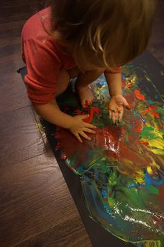 a young child is playing with an art project