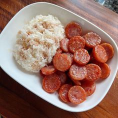 a white bowl filled with rice and pepperoni