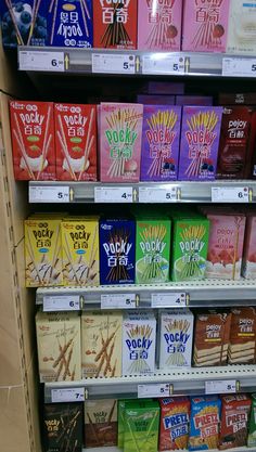 a shelf filled with lots of different flavored snacks