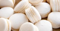 several white macaroons are stacked on top of each other in this close up photo
