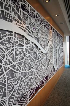 a large white city map on the wall in an office building with carpeted flooring