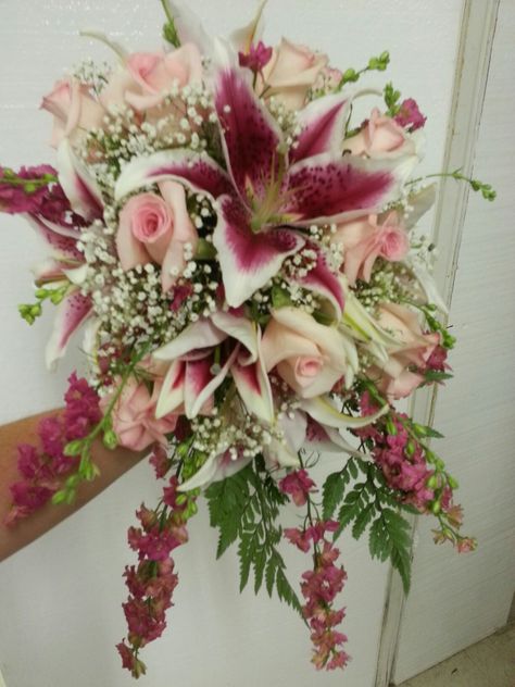 Stargazer lilies, pink roses, larkspur and baby's breath. Made in a bouquet  holder Floral, Flowers Bouquet, Beautiful Bouquet Of Flowers, Flower Arrangements, Flower Bouquet Wedding, Lily Bouquet Wedding, Flower Arrangements Simple, Cherry Blossom Wedding Centerpieces, Flower Bouqet